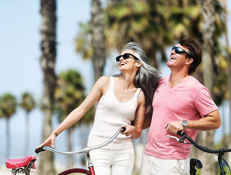 couple in sunglasses with their bikes.