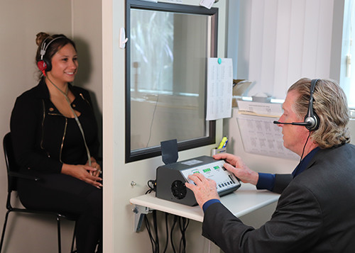 Keith Michaels, Au.D., administering a hearing test